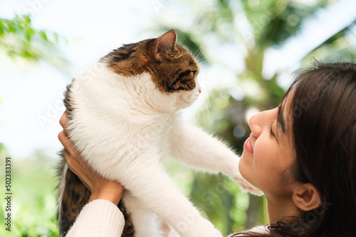 Young Asian woman working from home with her cat