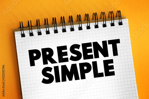 Present Simple - one of the verb forms associated with the present tense in modern english, text concept on notepad photo