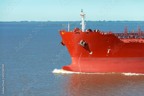 Front view of bow of large tanker cargo ship. Performing cargo export and import operation.