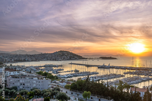 Aerial view of bay of kusadasi port parked with yachts and boats at sunset photo