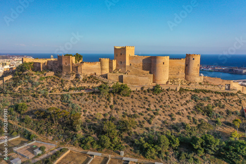 Aerial view of the Alcazaba of Almería a fortified complex with the ocean in the background of Almería, Andalusia, Spain. photo