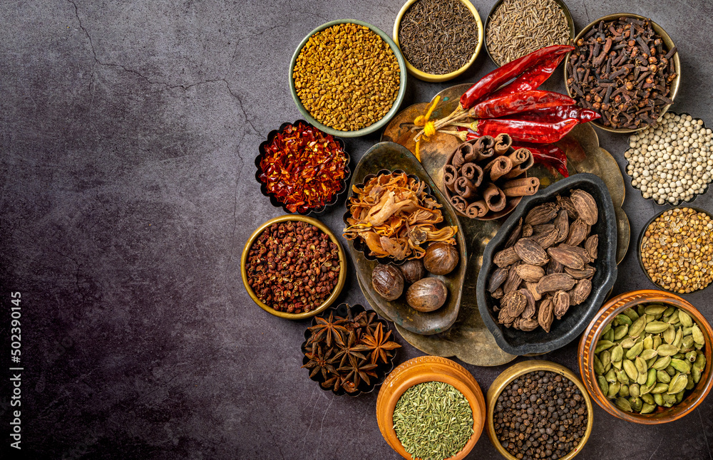 Top view of various Indian spices and seasonings on a table - obrazy, fototapety, plakaty 