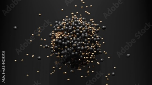 Black and gold geometric 3D balls hit each other with a magnet in a pile in the form of a ball in the air photo