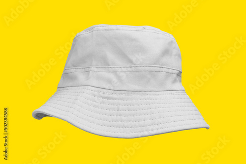 white bucket hat isolated on yellow