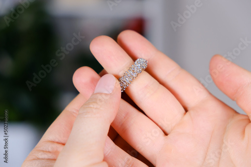 Massage ring for fingers in female hands close-up. Su Jok therapy, diagnosis and treatment of diseases, acupuncture and acupressure.