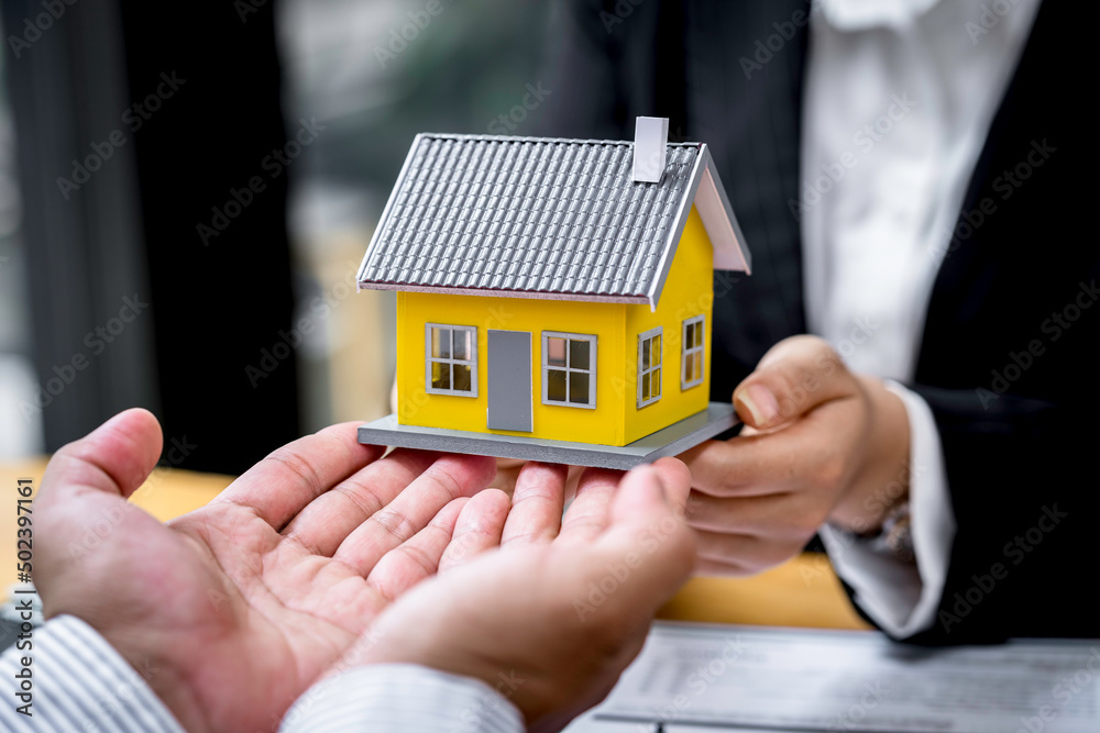 Sale representative offer house purchase contract to buy a house or apartment or discussing about loans and interest rates Sale representative offer house purchase contract to buy a house or apartment or discussing about loans and interest rates