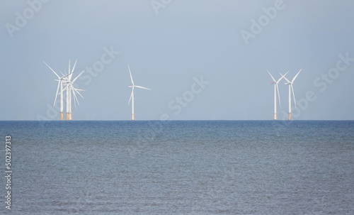 Beautiful view of wind turbines in the North Sea off the coast of Norfolk, UK photo