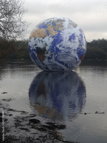 Vertical shot of the Floating Earth sculpture by artist Luke Jerram. Wigan, UK photo