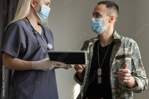 medical worker with military officer patient in hospital photo
