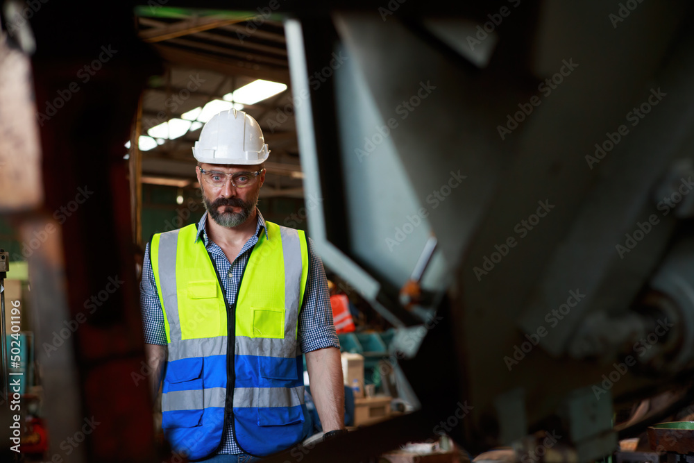 Caucasian male engineer Inspection, control, maintenance, machinery for the production of metal parts in industrial plants Caucasian male engineer Inspection, control, maintenance, machinery for the production of metal parts in industrial plants