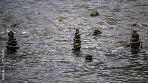 Photography Shot of zen stones in the water in the daytime.