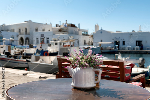 Flower arrangement in teapot on the table of a taverna in Paros