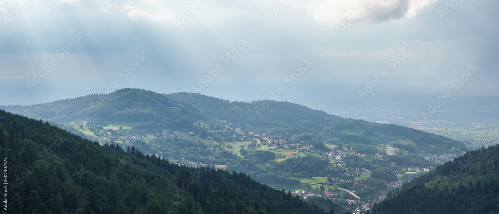 Panorama of Black Forest village with sunbeams shining on the landscape, Buehlertal, Germany