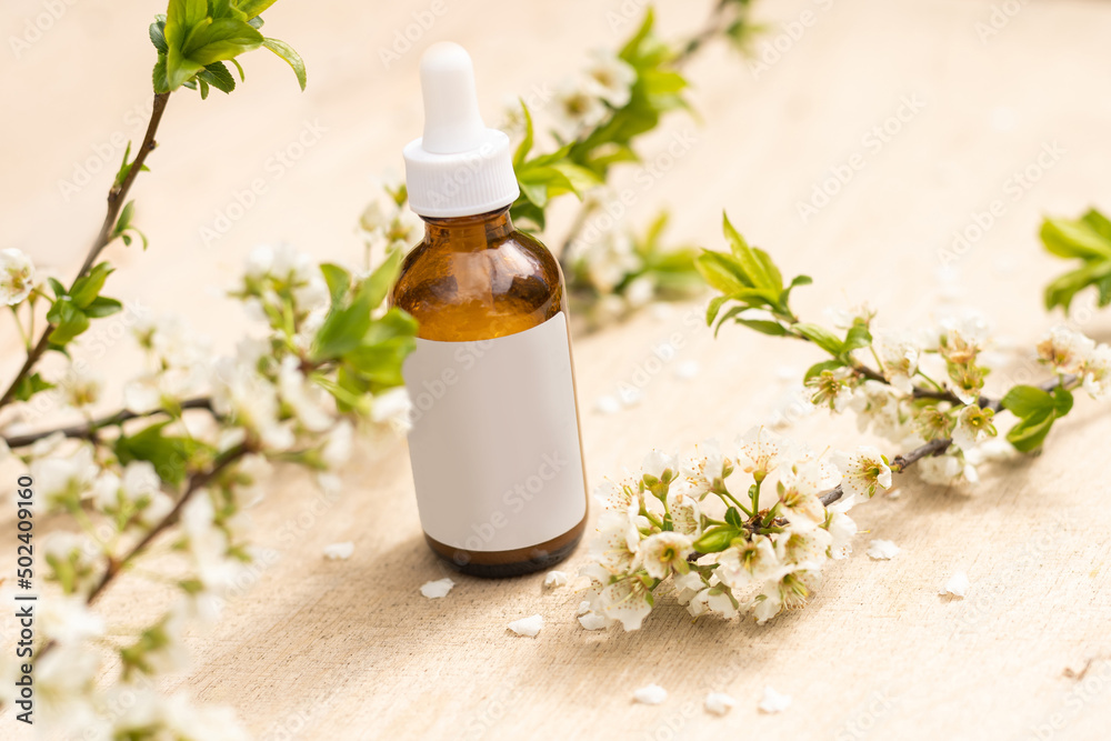 Top view of mockup of white squeeze bottle tube. small white flowers. medicine or cosmetics - cream, gel, skin care, toothpaste. Top view of mockup of white squeeze bottle tube. small white flowers. medicine or cosmetics - cream, gel, skin care, toothpaste.