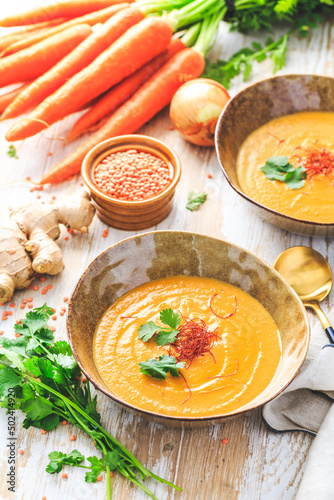 Homemade red lentil soup with carrots, ginger and coconut milk photo