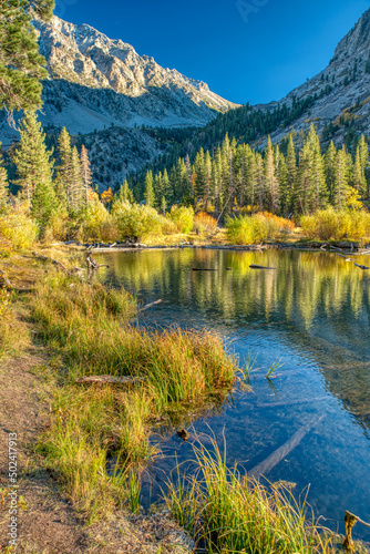 Vertical scenic view of the Lundy Canyon with a lake in Sierra Nevada photo