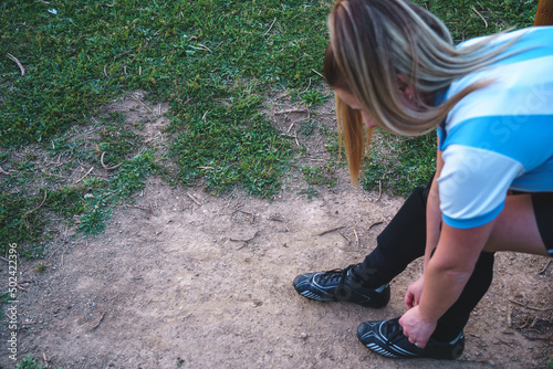 soccer girl tying shoelaces on sneakers