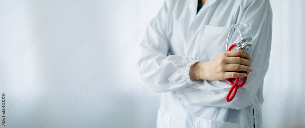 A doctor standing with his arms crossed holding a stethoscope, a doctor from the hospital. Medical staff people. Team of doctor and nurse in hospital. Concept Of Medical and Healthcare Business. A doctor standing with his arms crossed holding a stethoscope, a doctor from the hospital. Medical staff people. Team of doctor and nurse in hospital. Concept Of Medical and Healthcare Business.
