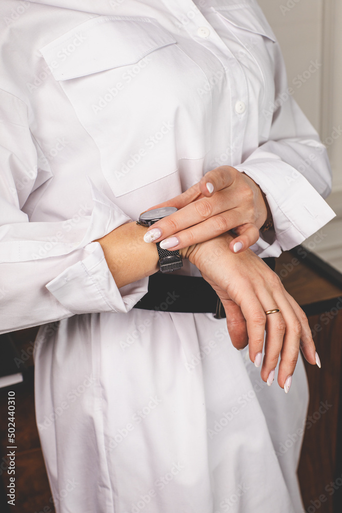 a woman with a black watch on her hand, close-up