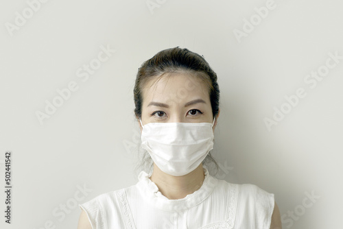 Close up portrait of beautiful young Asian woman wearing protective mask corona virus prevention. Free space for text mockup banner. Avoid contaminating Corona virus Covid-19 concept.