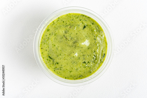 green sauce dip on white