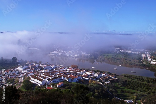 Sanlúcar de Guadiana en España y Alcoutim en Portugal entre la niebla matutina. Dos pueblos situados a orillas del rio Guadiana que sirve de frontera natural entre ambos países. photo