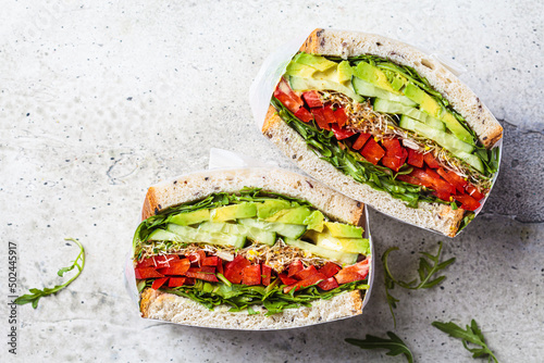 Vegetable sandwich in paper wrap. Vegan healthy food, takeaway food.