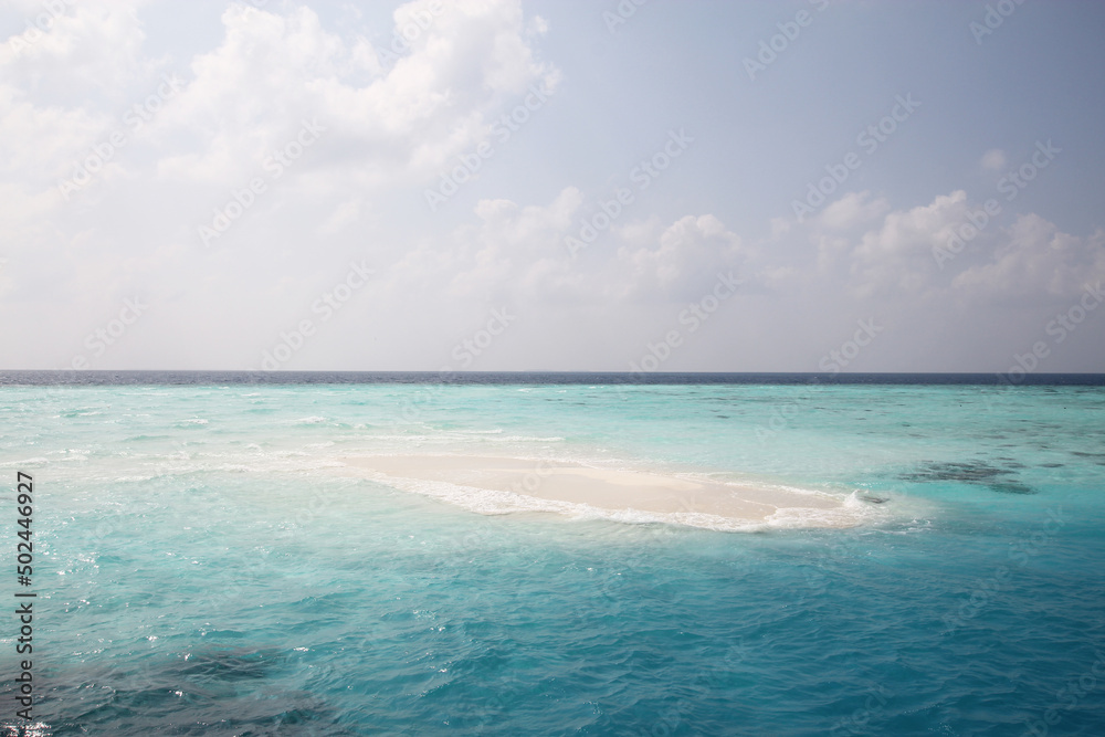 Maldives. Small island in the Indian Ocean. Blue sky and clean turquoise water.
