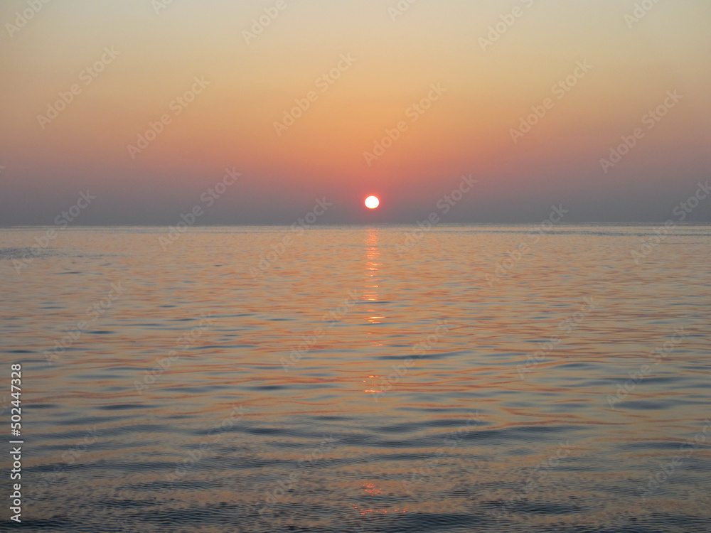 Sunset background. Maldives. Sunset over the Indian Ocean. The solar path is of high quality in the water.