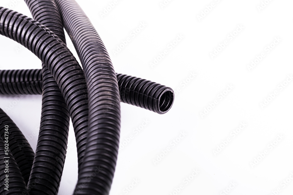on a white background. black corrugated tube for laying cable in the car