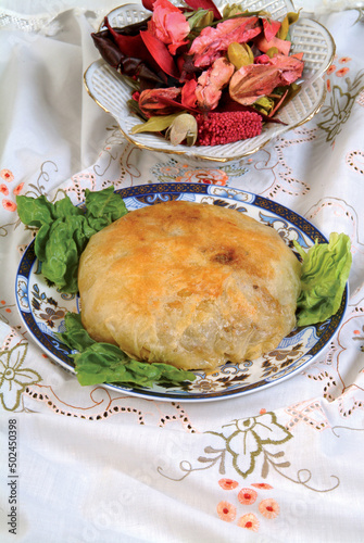 Bastila traditional Moroccan dish, pie filled with chicken, eggs, onions, sugar, almond, pigeon meat, fish. Moroccan specialties photo