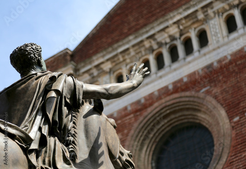 Bronze statue of the knight called REGISOLE and the Cathedral of Pavia City in Northern Italy
