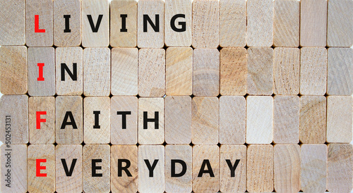 LIFE living in faith everyday symbol. Concept words LIFE living in faith everyday on wooden blocks on beautiful wooden background. Business LIFE living in faith everyday concept. Copy space. photo