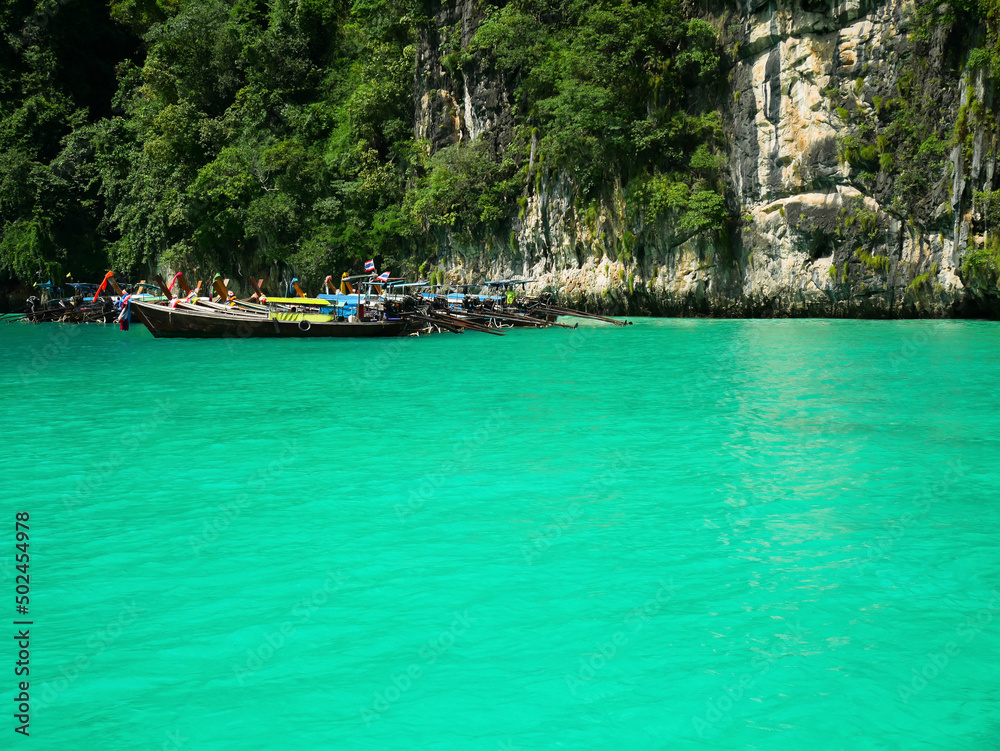 Long-tail boats with crystal clear water at Pileh lagoon, Krabi, Thailand.