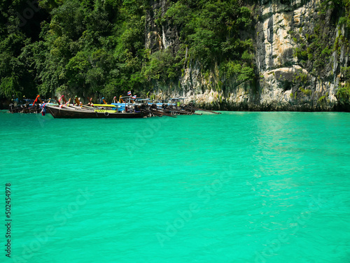 Long-tail boats with crystal clear water at Pileh lagoon, Krabi, Thailand.