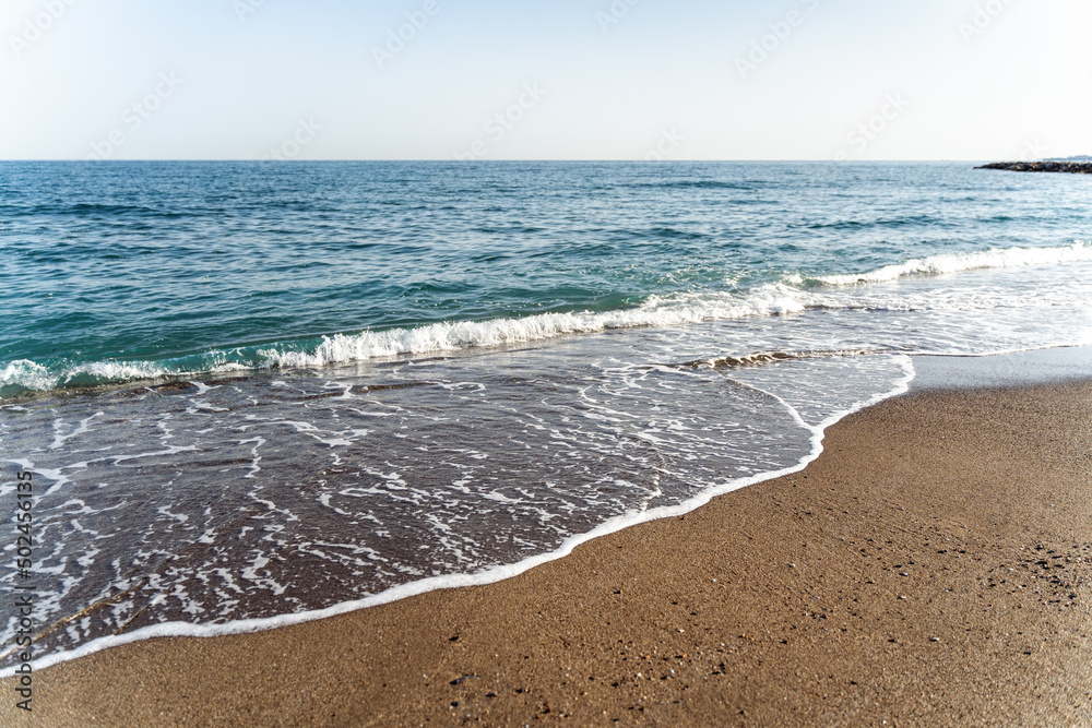 Full length view of the empty tropical beach with calm seashore and blue water Full length view of the empty tropical beach with calm seashore and blue water