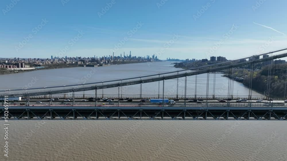Aerial view of George Washington Bridge in Fort Lee, NJ. George Washington Bridge is a suspension bridge spanning the Hudson River connecting NJ to Manhattan. Aerial view of George Washington Bridge in Fort Lee, NJ. George Washington Bridge is a suspension bridge spanning the Hudson River connecting NJ to Manhattan.