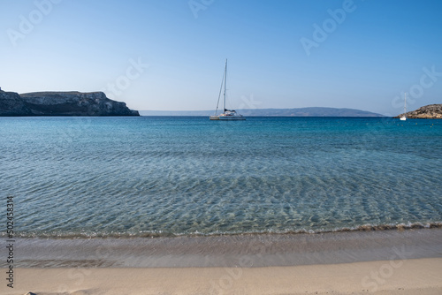 Sail boat moored at Elafonisos island, Greece. Simos sandy beach, turquoise sea water, blue sky