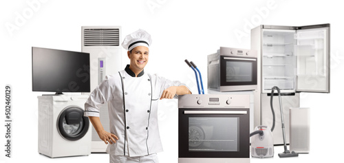 Male chef smiling and posing with electrical home appliances