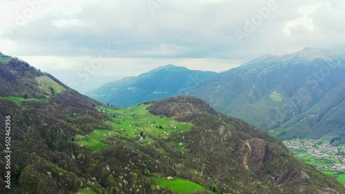 Aerial video of the small town of Pasturo in Lombardy, North Italy showing mountain panorama, forest and old cottages in the small village. Footage 4k, drone view photo