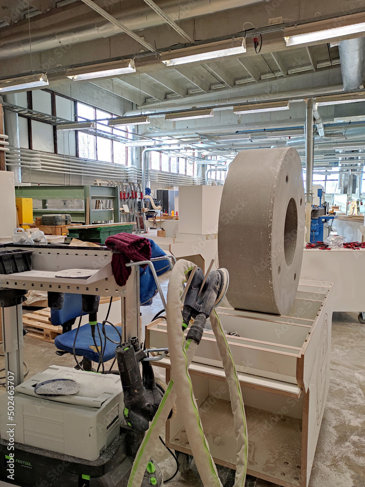 A large workshop with machines and material for the manufacture of furniture. Working production.