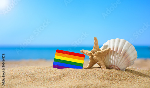 LGBT flag on a tropical beach. Seashell and starfish nearby