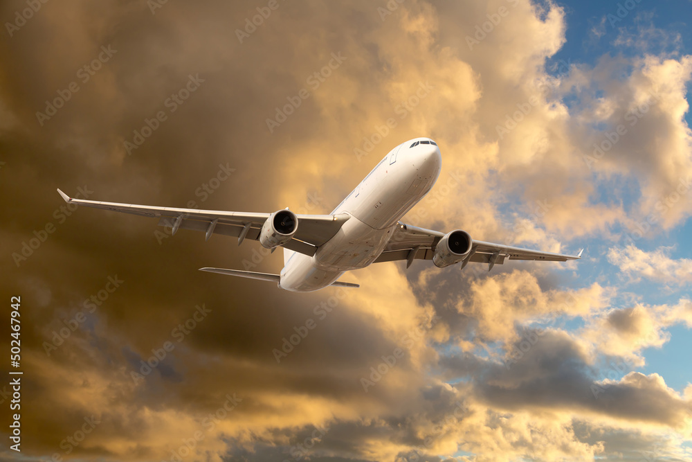 Civil passenger plane in flight. Aircraft climb into the sunset sky. Airplane front view.