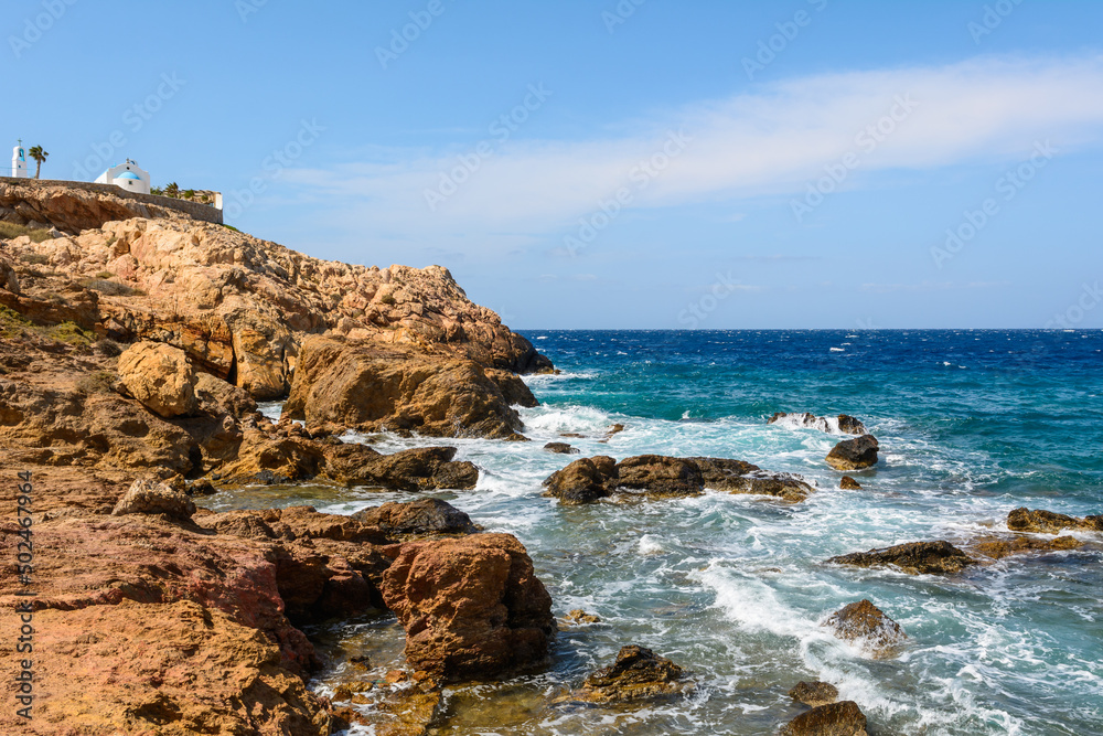 Rocky coast of Koumbara beach located on Ios Island. Cyclades, Greece Rocky coast of Koumbara beach located on Ios Island. Cyclades, Greece