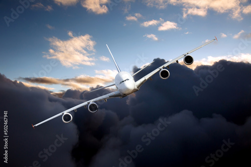 Passenger plane in flight. Aircraft with left heeling flies high in the blue sky through the dark clouds. Front view of airplane.