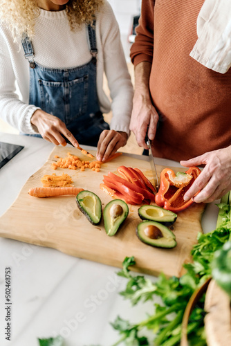 Couple preparing food in kitchen.