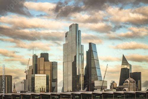Cityscape of big buildings in London, on a cloudy day at the sunset.
