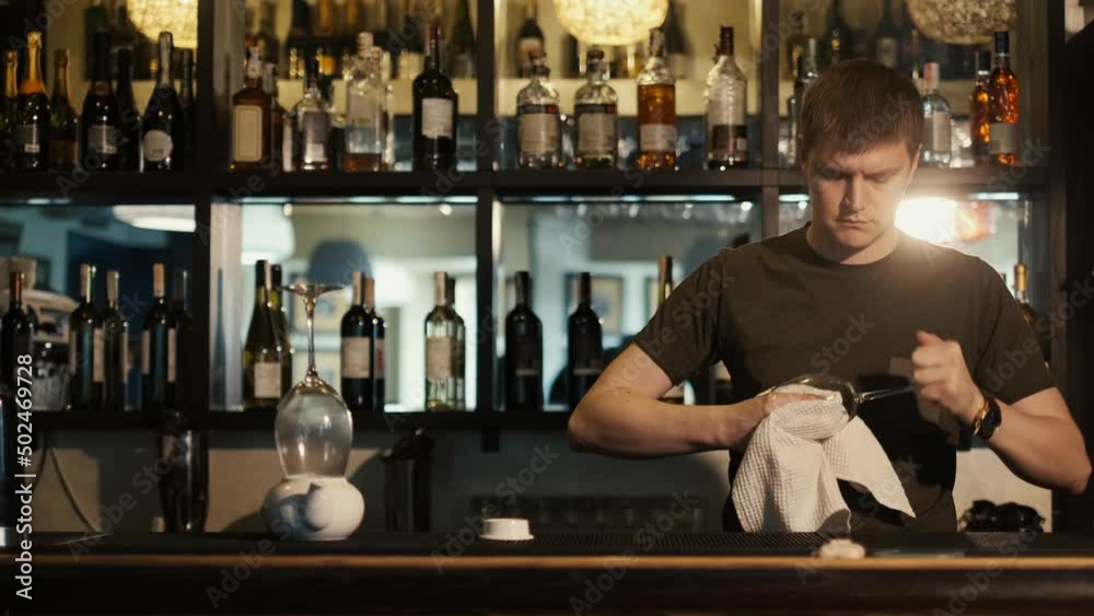 Barman rub metal shakes with napkin at work place Barman rub metal shakes with napkin at work place