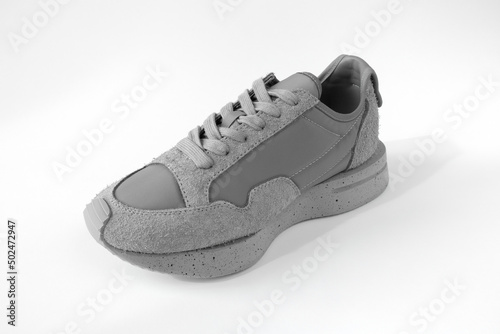 one grey sneaker on white background