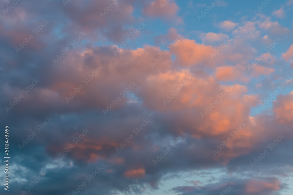 Dramatic sunset clouds against blue sky at dusk to night. Nature, freedom, peaceful concept
